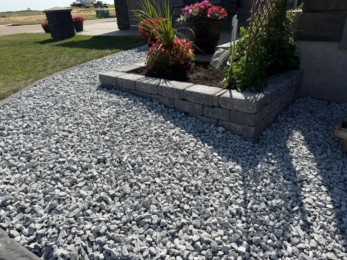 A segmental block retaining wall edging a planted bed